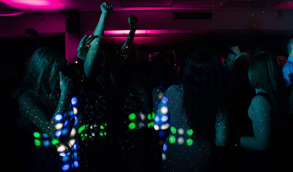 Crowd dancing on a packed nightclub floor at peak time