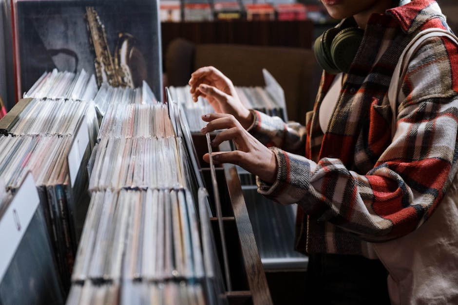 DJ flipping through a crate of vinyl records before a gig